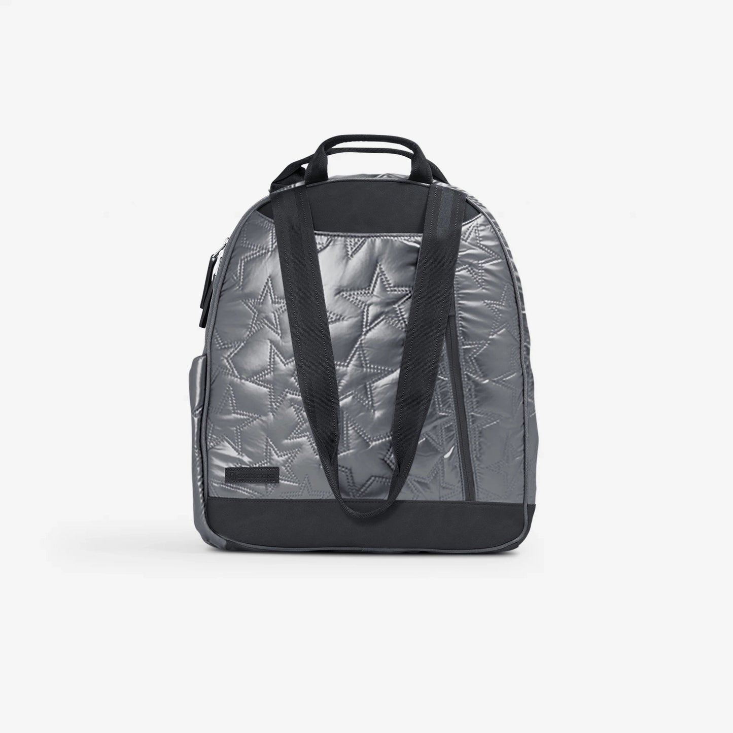 The Doubletake MELBIE Pickleball Backpack & Tote is a shiny silver bag with a star quilted pattern, black handles, an adjustable shoulder strap, black trim and base, and a small black front patch. It stands upright on a white background.