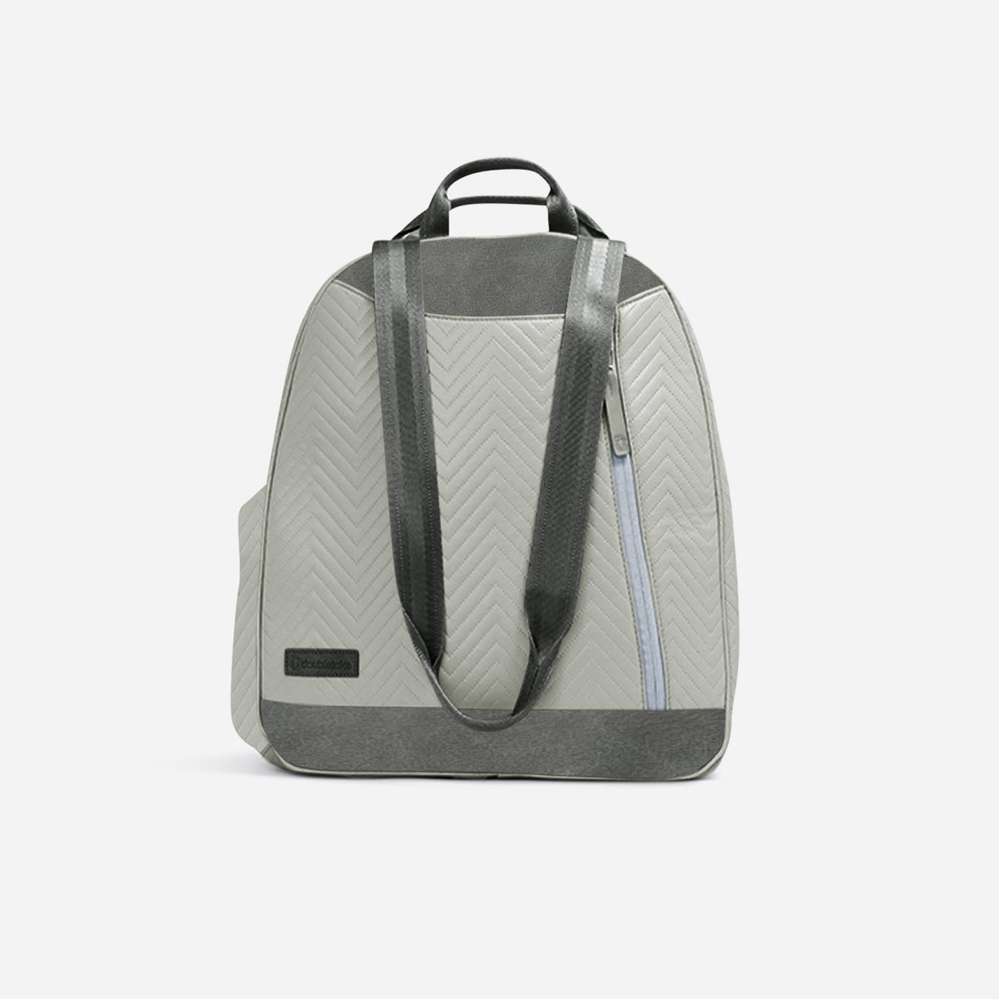 The Doubletake MELBIE Pickleball Backpack & Tote is a stylish light gray bag with dark gray chevron-patterned fabric, two black shoulder straps, a top handle, front pocket with light blue zipper, and a black logo patch on the lower left.