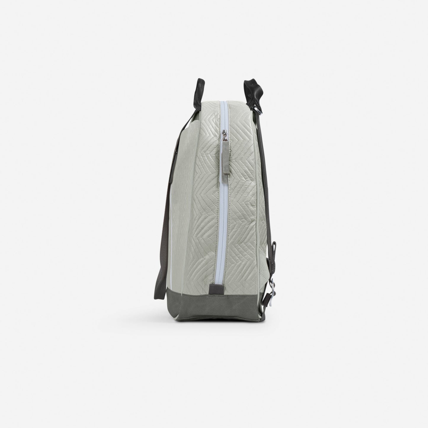 A side view of the MELBIE | Pickleball Backpack & Tote by Doubletake in light gray with a quilted geometric pattern, light blue zipper, dark gray base and shoulder strap. Water resistant design shown on a plain white background.