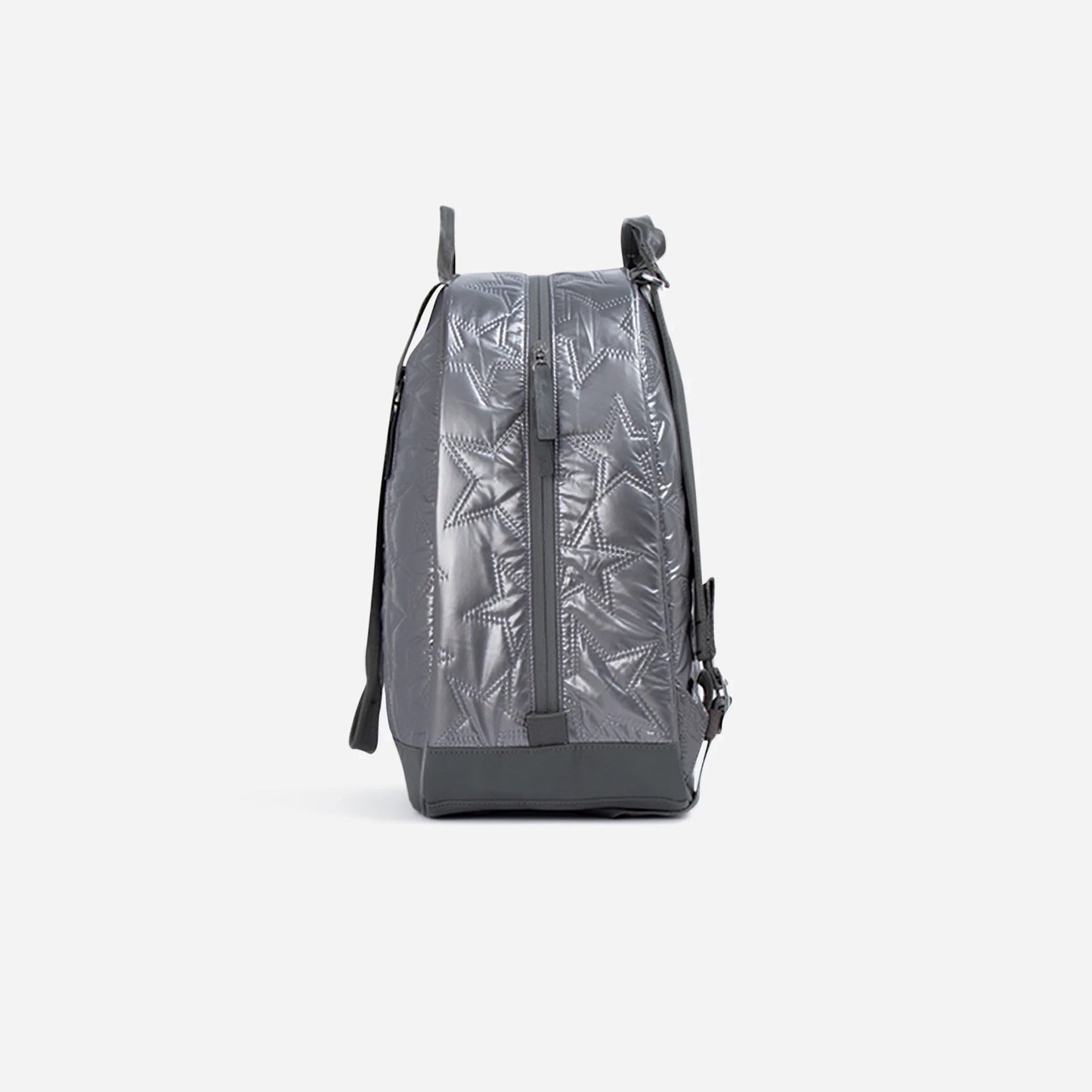 A side view of the Doubletake MELBOURNE | Pickleball Backpack & Tote in gray, showcasing its water-resistant, shiny textured surface with embossed star patterns, vertical side zipper, and shoulder strap against a white background.