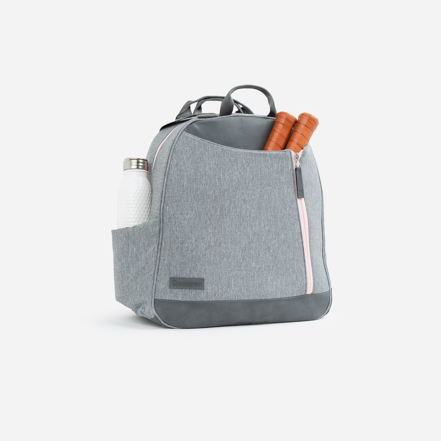 The MELBOURNE | Pickleball Backpack & Tote by Doubletake is shown in light gray with a pink zipper, black accents, and a tip-free design. The front pocket holds two wooden-handle paddles; a white water bottle fits in the side pocket. Background is plain white.