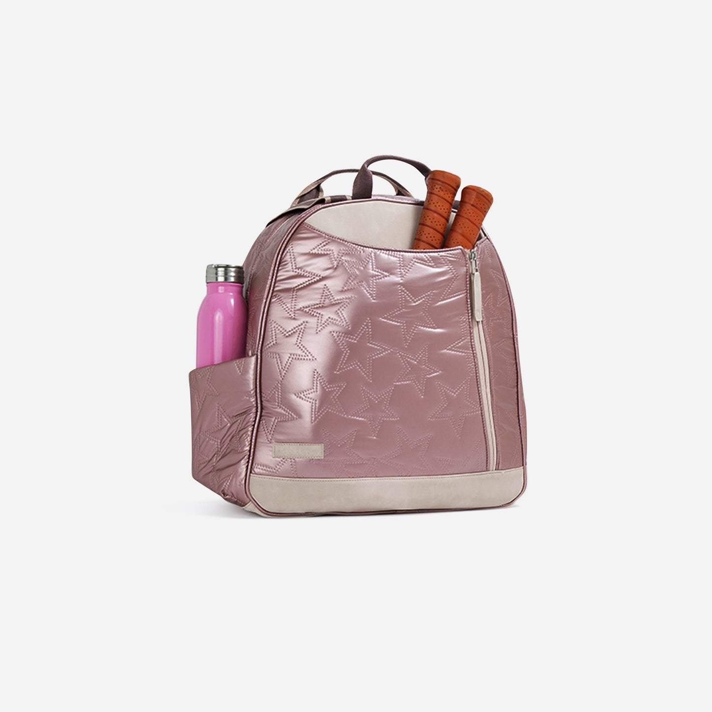 The Doubletake MELBOURNE Pickleball Backpack & Tote shines in pink with embossed stars, two brown-handled rackets peeking out, a pink water bottle in the side pocket, a water-resistant finish, front zipper pocket, and dual top handles.