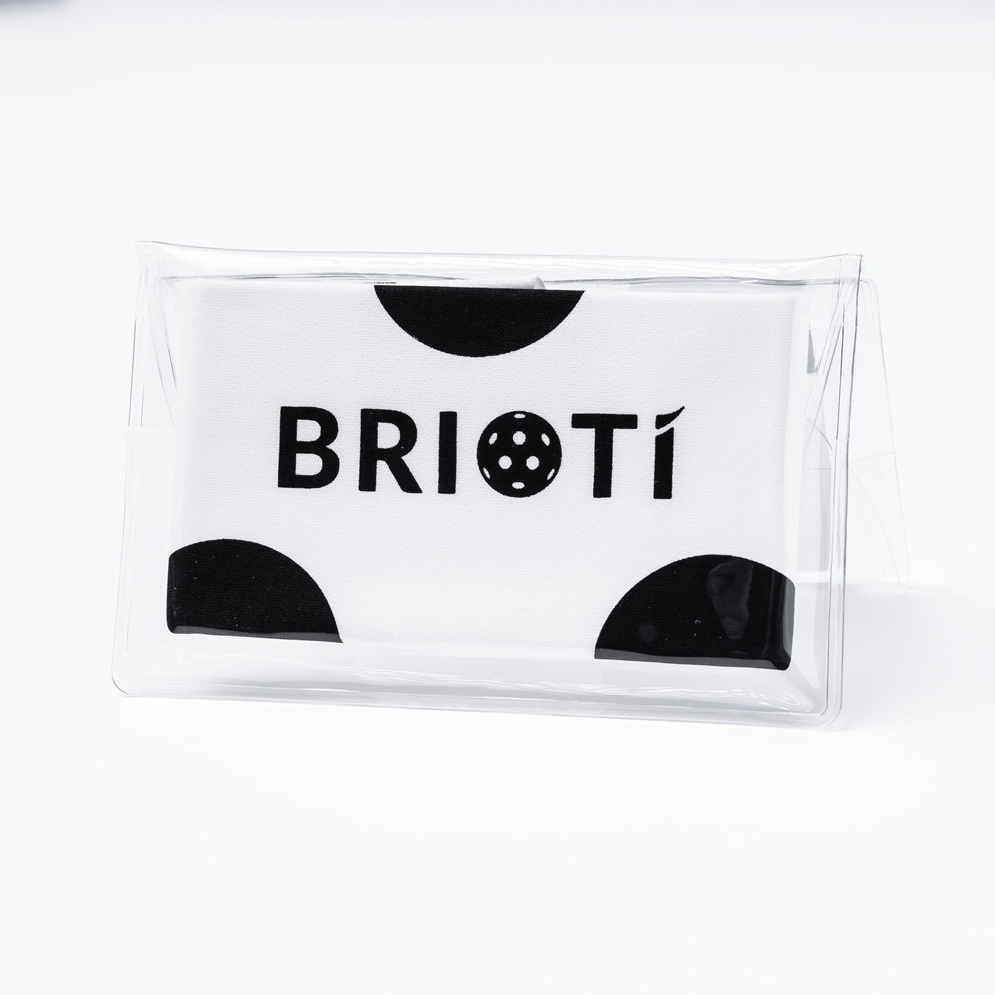 A white rectangular Lens Cleaning Cloth by BRIOTI features black semicircle accents and bold “BRIOTI” text with a stylized “O,” encased in clear plastic against a white background.