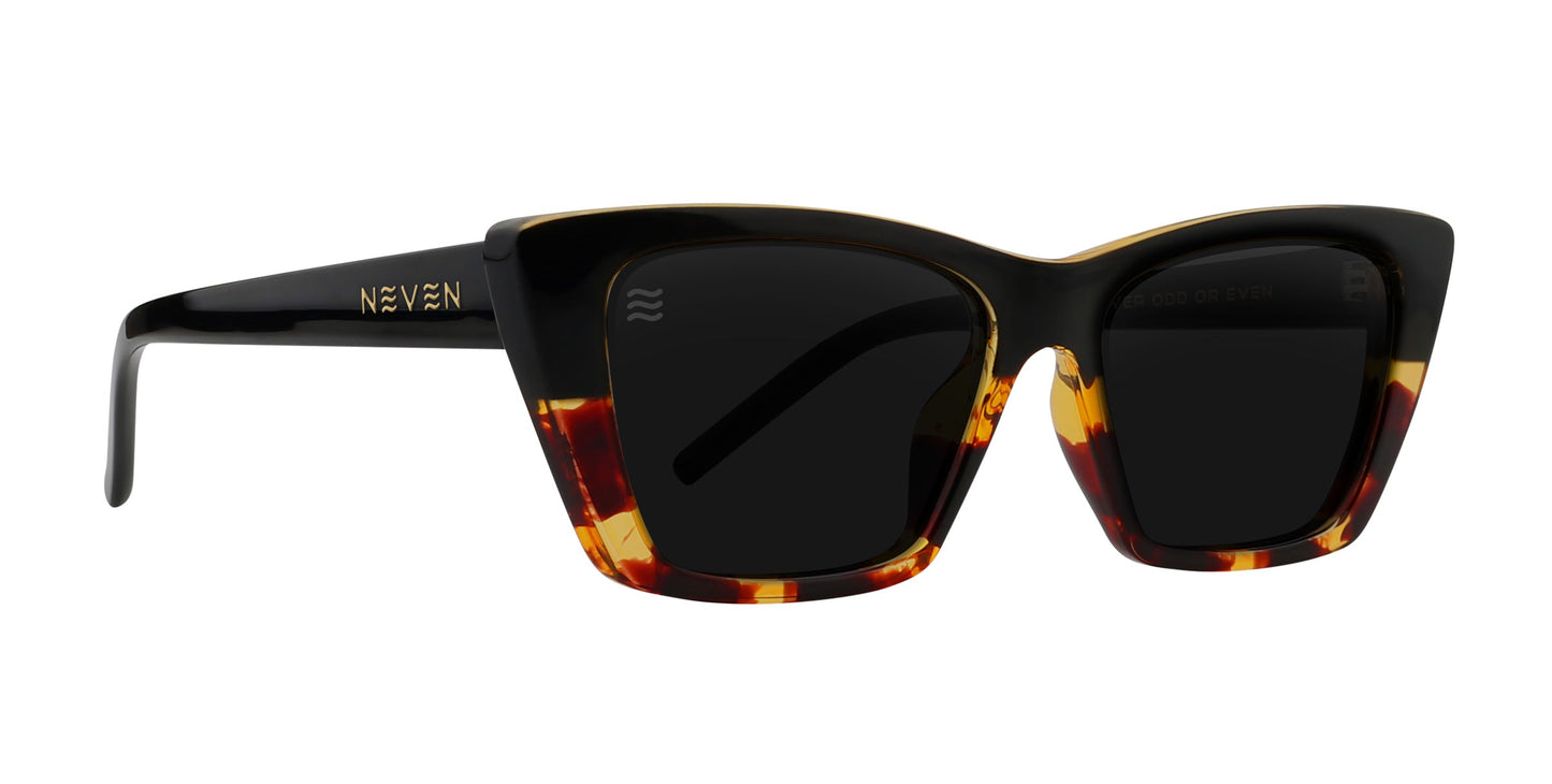 The Dusk by Neven Eyewear features cat-eye sunglasses with thick, glossy black tortoise frames in dark brown and amber. Rectangular lenses offer polarized UV400 protection, and "NEVEN" is printed in gold on the left temple. Set against a plain white background.
