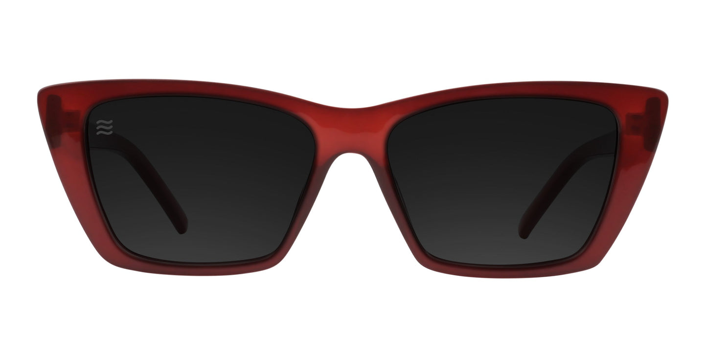 The Espresso cat-eye sunglasses from Neven Eyewear feature thick, glossy mahogany brown frames with pointed upper corners, large black polarized UV400 lenses, an inward-curved bridge, and a small white logo on the upper left lens.