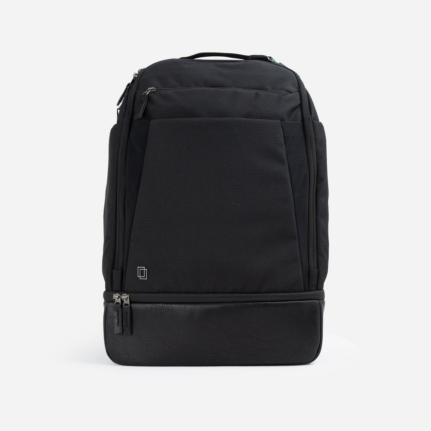 The Doubletake NYC Pickleball Backpack is a sleek black bag with a modern, structured design. It has a top handle, dual bottom-front zippers for paddles, a small square logo, and minimalist paneling. Shown on a plain white background.