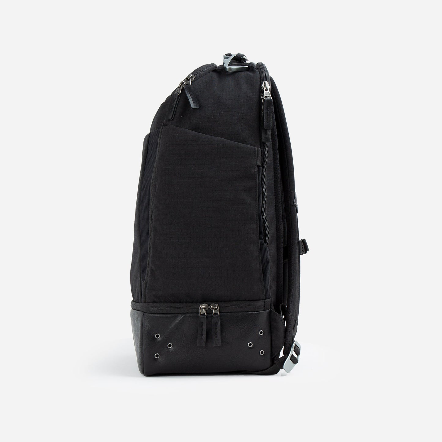 The Doubletake NYC Pickleball Backpack stands upright, viewed from the side, with a sleek black design and multiple zippered compartments—including dedicated paddle sections—its modern look accentuated by a plain white background.