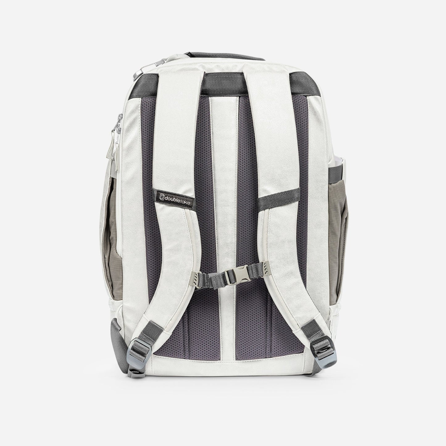 The Doubletake NYC Pickleball Backpack, shown in white and gray from the back, features padded adjustable shoulder straps, a sternum strap, mesh back padding, top handle, side pockets for gear, and a Cravocoredo logo label on one strap.