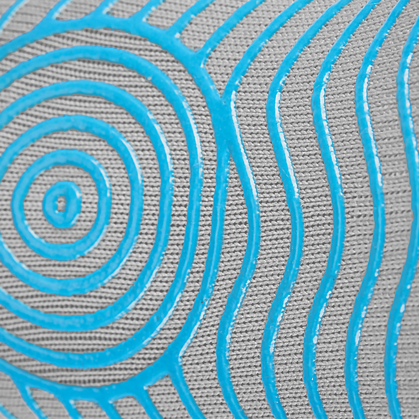 A close-up of GripSocks Athletic Socks with Grips shows textured grey fabric and raised, shiny blue lines—concentric circles on the left, wavy parallels on the right—creating bold contrast for non-slip performance in training or everyday use.