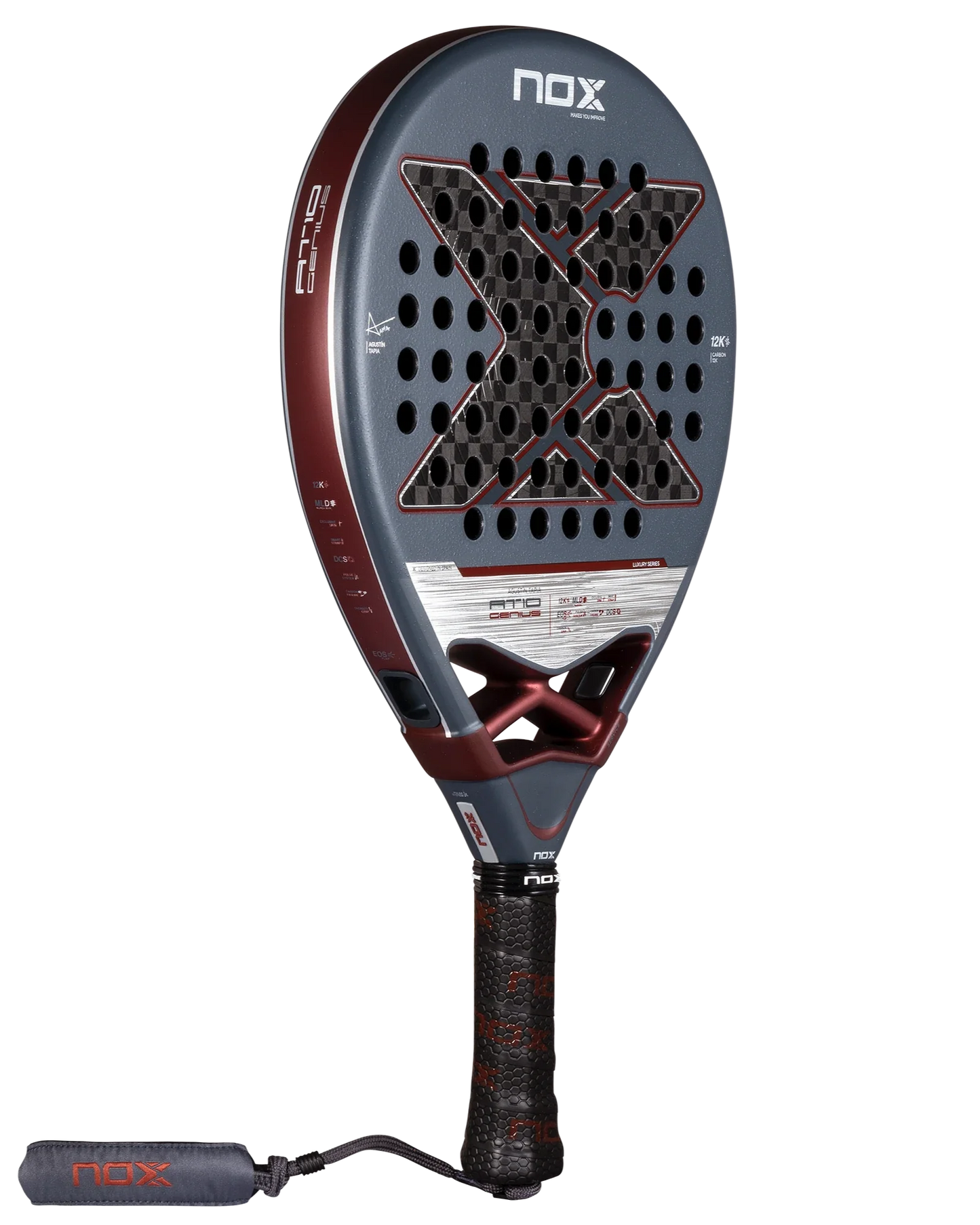 The Nox AT10 Luxury GENIUS 12K 2025 by Agustin Tapia from Padel USA has a rounded teardrop shape, large X of small holes, grey and red design, 12K carbon fiber build, textured black grip, and a wrist strap on the handle.