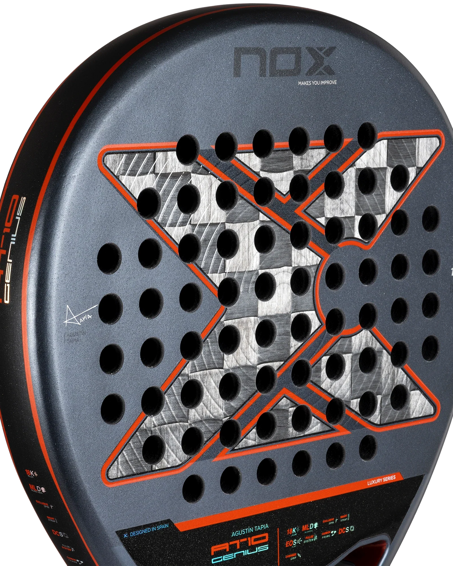 Close-up of the Nox AT10 Luxury GENIUS 18K Alum by Agustín Tapia, available at Padel USA, with a metallic “X” design, EXCLUSIVE SPIN tech, and orange accents on a black frame. Branding and technical details are visible on the edge. White background.