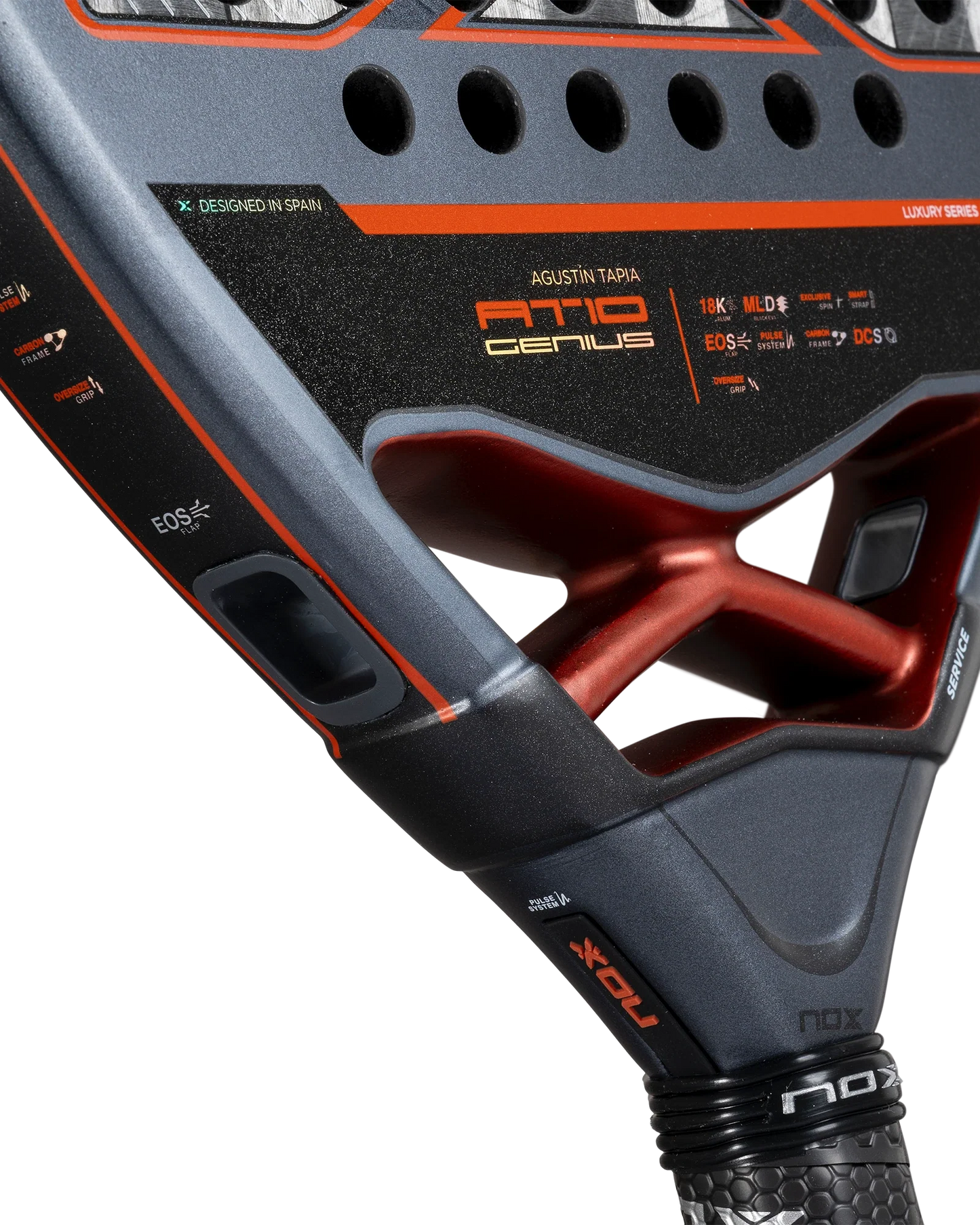 Close-up of the Nox AT10 Luxury GENIUS 18K Alum by Agustín Tapia from Padel USA, showcasing a black, grey, and red design with NOX Custom Grip and EXCLUSIVE SPIN tech, plus detailed branding and geometric cutouts for top performance.