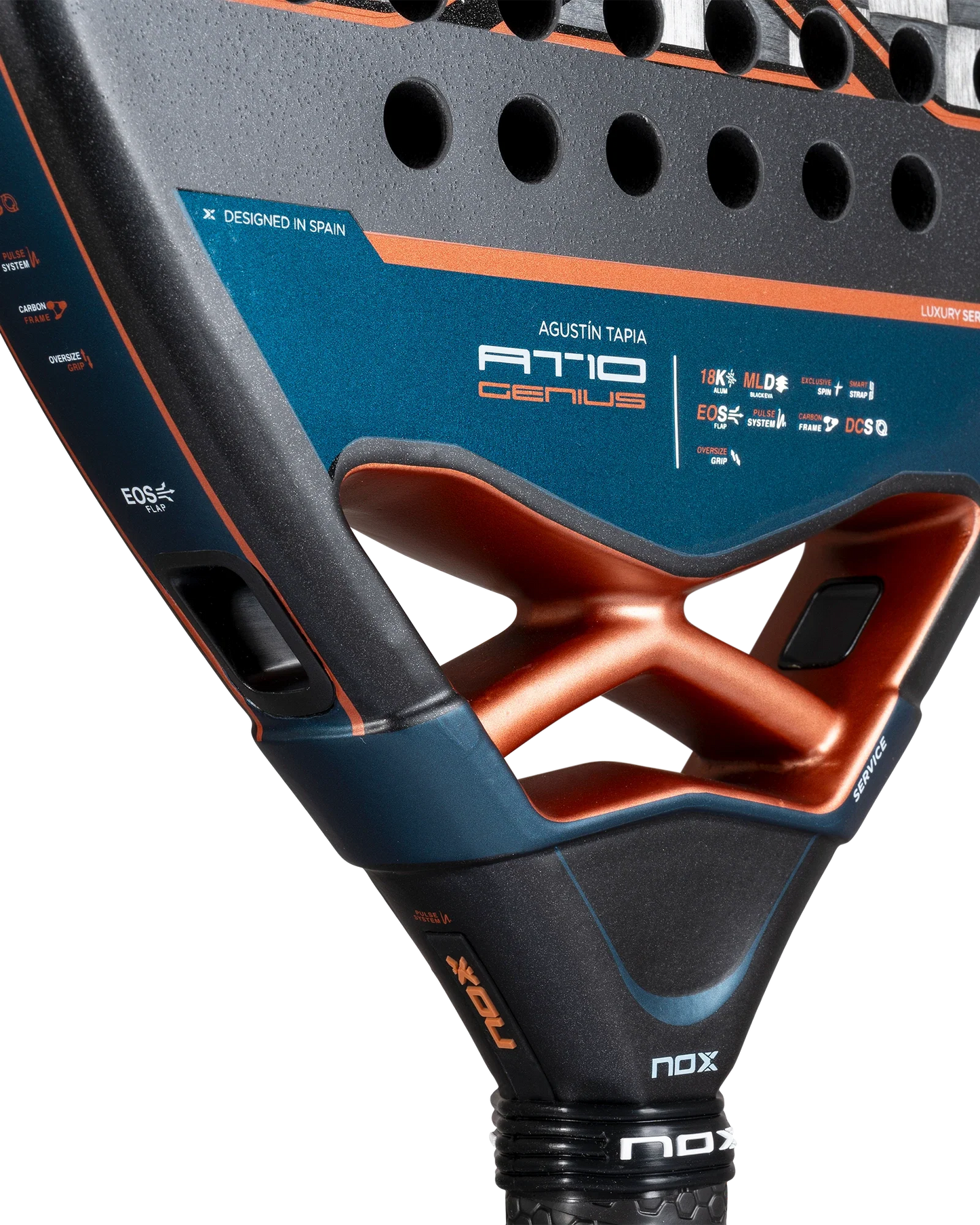 Close-up of the Nox AT10 Luxury GENIUS ATTACK 18K Alum 2025 padel racket by Agustin Tapia (Padel USA) in blue, orange, and black. Visible: EXCLUSIVE SPIN tech, 18K aluminized carbon, logos, textured surface, and structural holes.