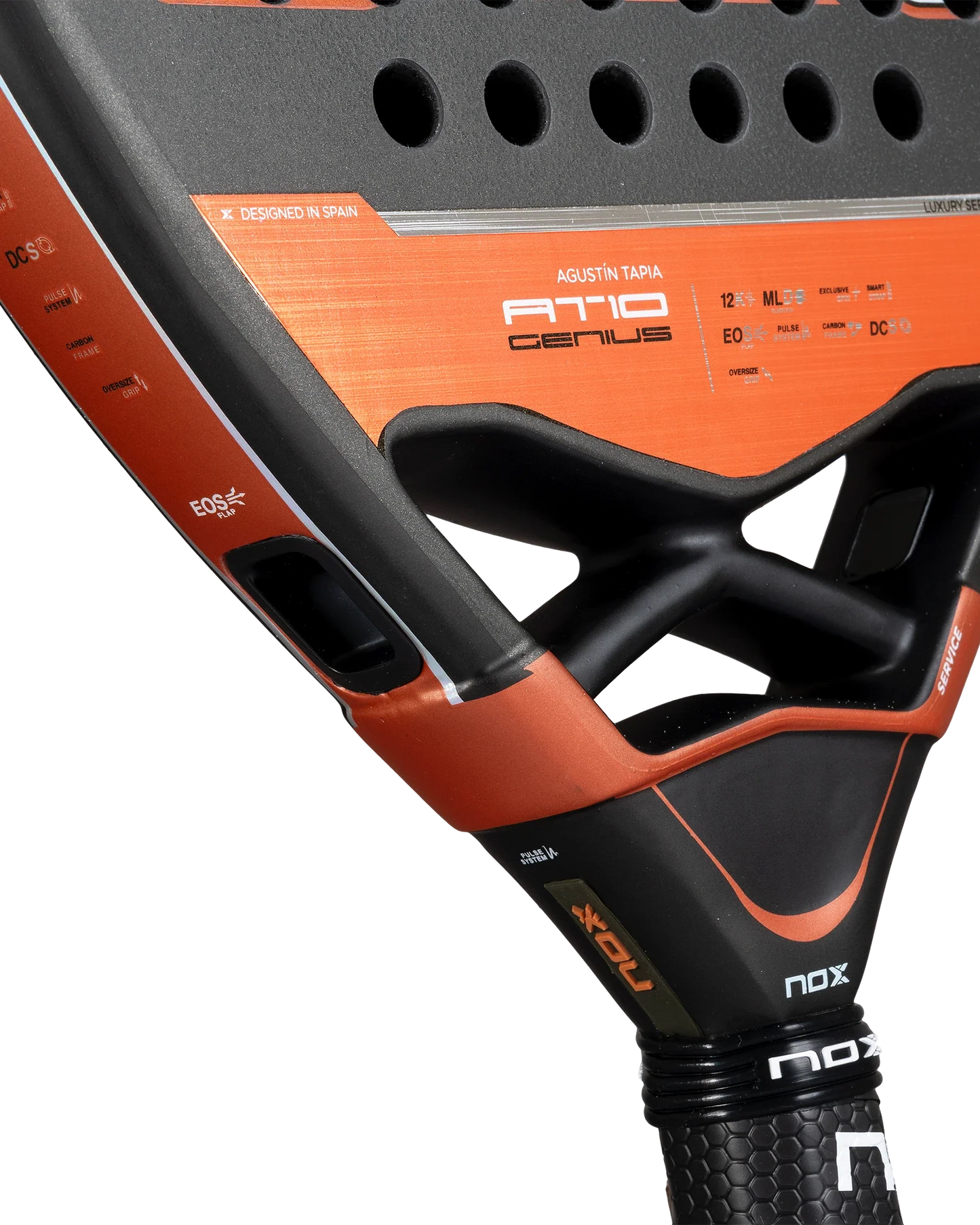 Close-up of the black and orange Nox AT10 Luxury GENIUS ATTACK 12K 2025 by Agustin Tapia from Padel USA, highlights include diamond shape, 12K carbon, EXCLUSIVE SPIN tech, technical details, logos, his name, textured surface, perforations and grip.