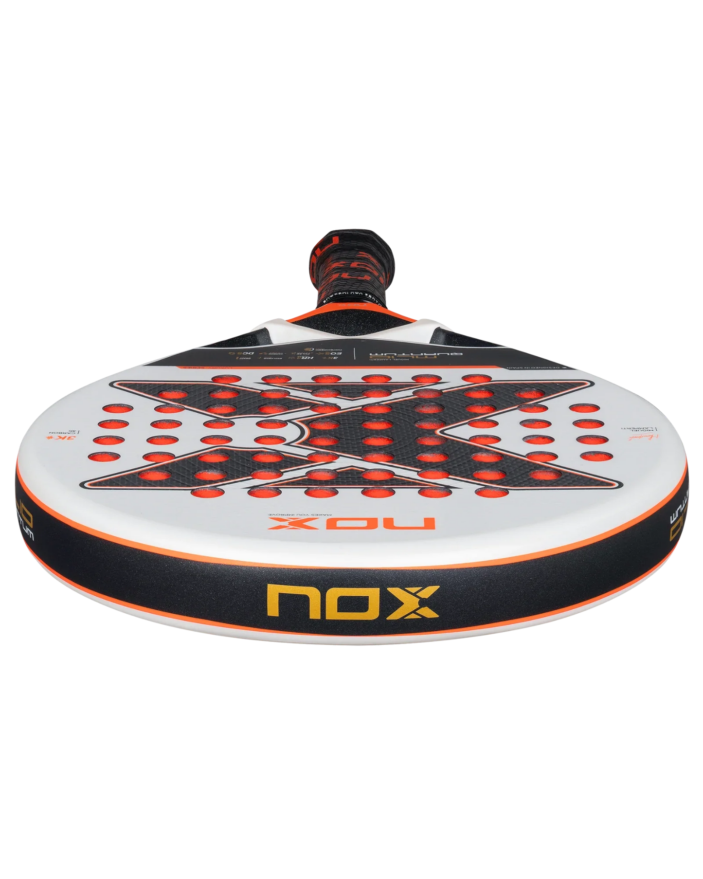 Close-up of the Nox ML10 QUANTUM 3K padel racket by Padel USA, featuring a white face with red and black accents, 3K carbon fiber, a large X in the center, circular holes, and a yellow NOX logo on the edge. Used by Miguel Lamperti.