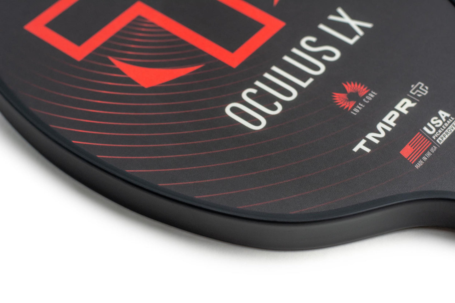 Close-up of the TMPR Sports Oculus LX pickleball paddle with Luxe Core technology, USA Pickleball Approved. The black paddle features red and white graphics, a red flame logo, and bold concentric red lines on a smooth edge.