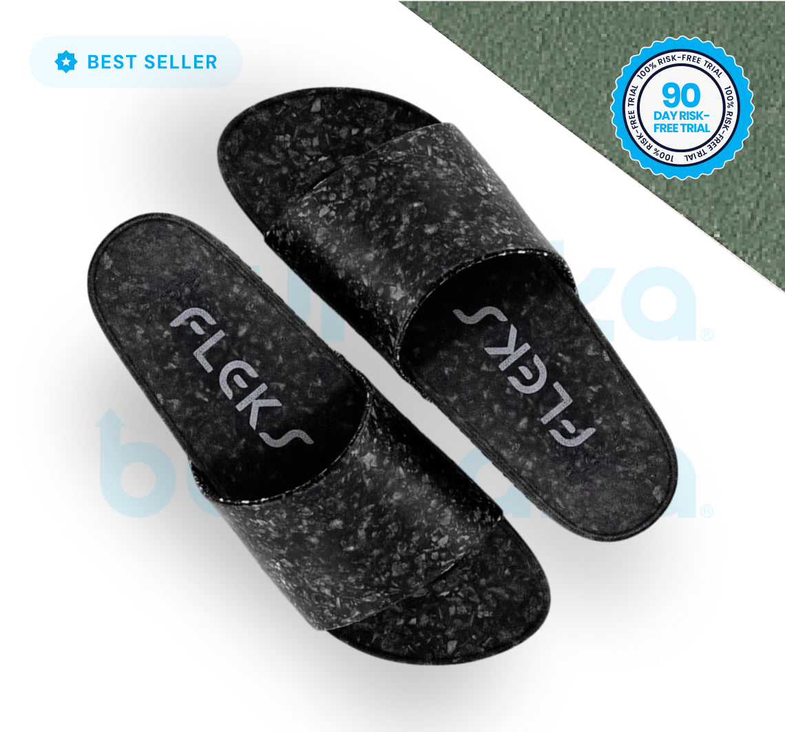 The Blumaka Fleks® East Beach Slide is a black sandal with a marbled texture and "FLEKS" in white on the footbeds, designed to support alignment and relieve soreness—shown on white with Best Seller and 90 Day Risk-Free Trial badges.