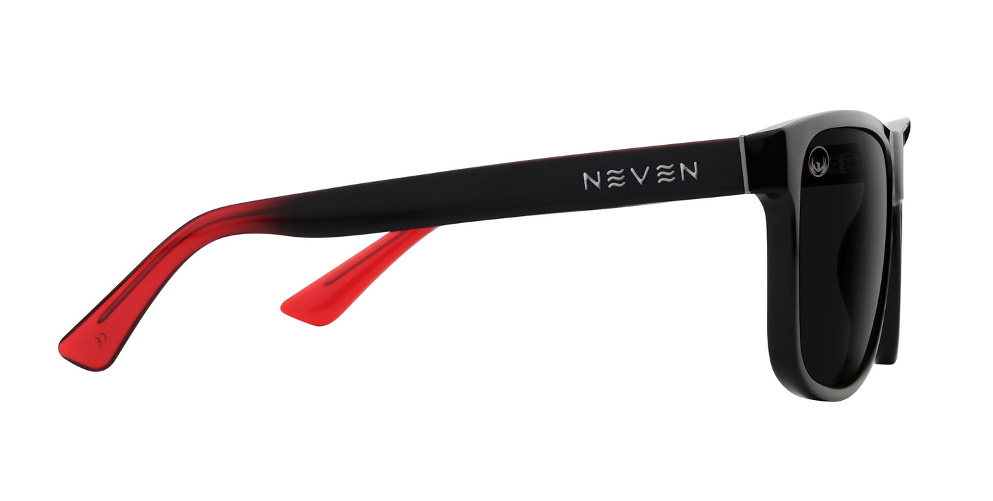 A close-up side view of black polarized Ignite sunglasses from Neven Eyewear. The brand name NEVEN in white, stylized letters is on the outer side of the red inner arm. The dark lenses are set against a plain white background.