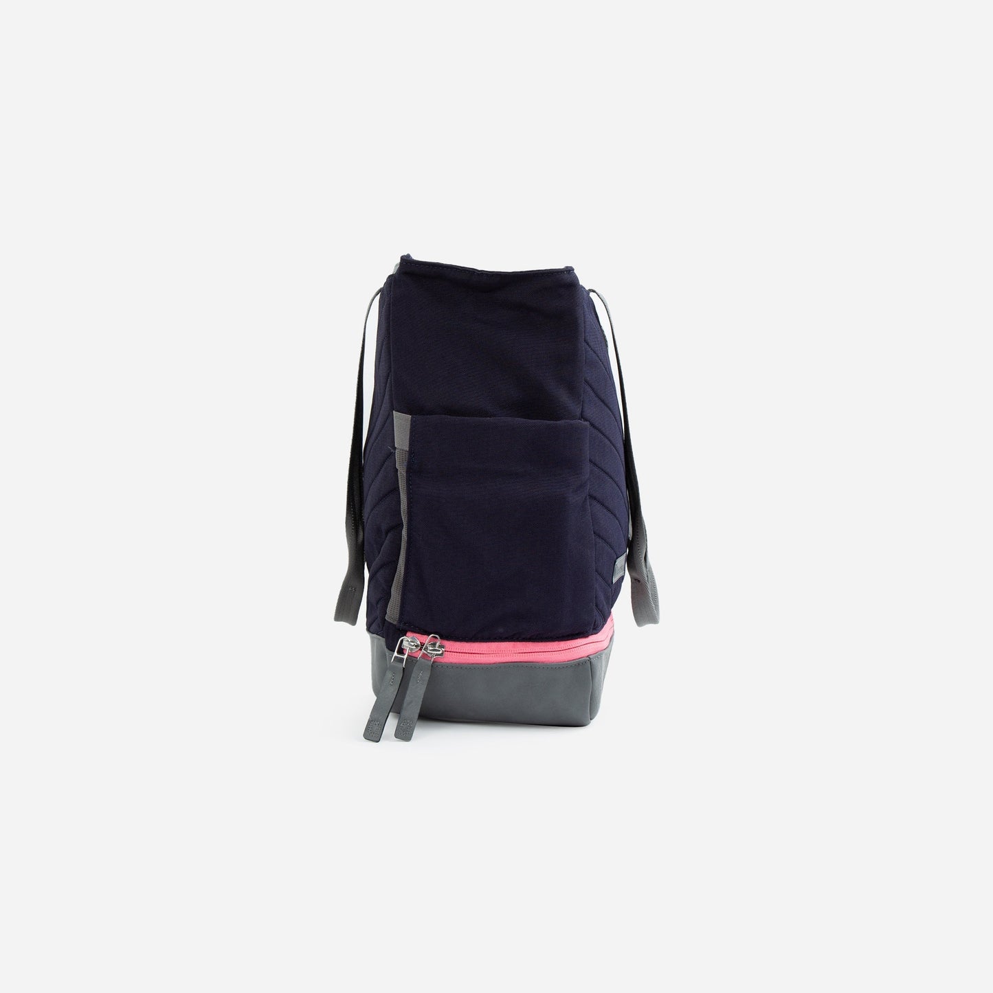 The Doubletake PARISII | Pickleball Tote is a navy blue bag with gray straps, a front pocket, gray bottom, and a pink double-pull zipper. Photographed upright on a white background, the tote’s front view highlights its versatile design.