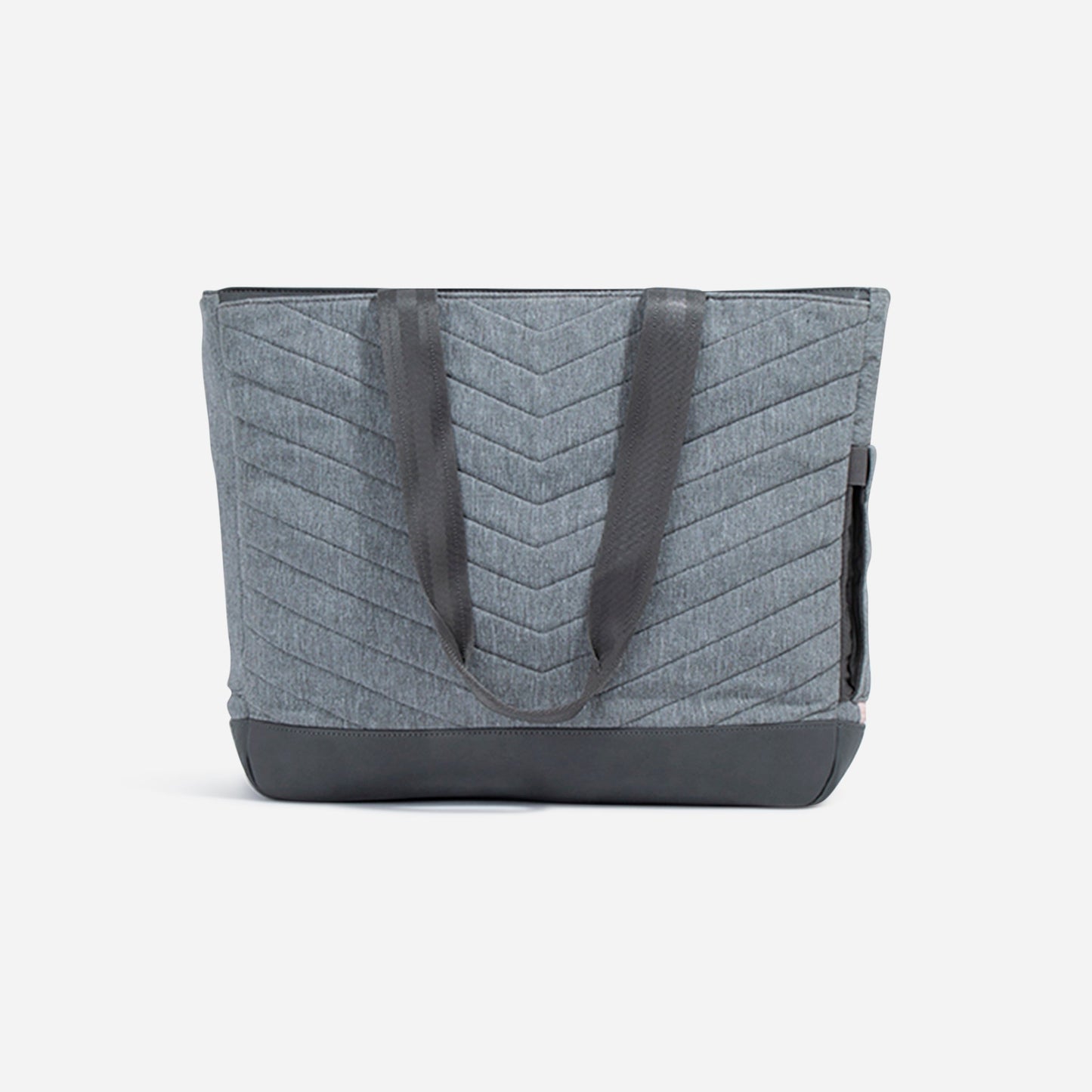 The Doubletake PARISII Pickleball Tote is a grey paddle bag with a chevron quilted pattern, black faux leather handles and base, plus side pockets. Shown against a plain white background, this tote combines function and minimalist style.