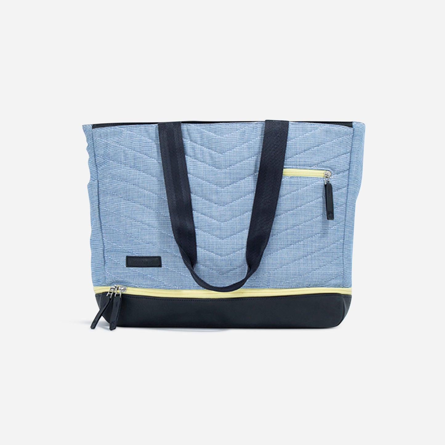 The PARISII | Pickleball Tote by Doubletake is a light blue quilted bag with black handles, black base, and yellow zippers. It features a front zip pocket and horizontal seam, showcased on a plain white background.
