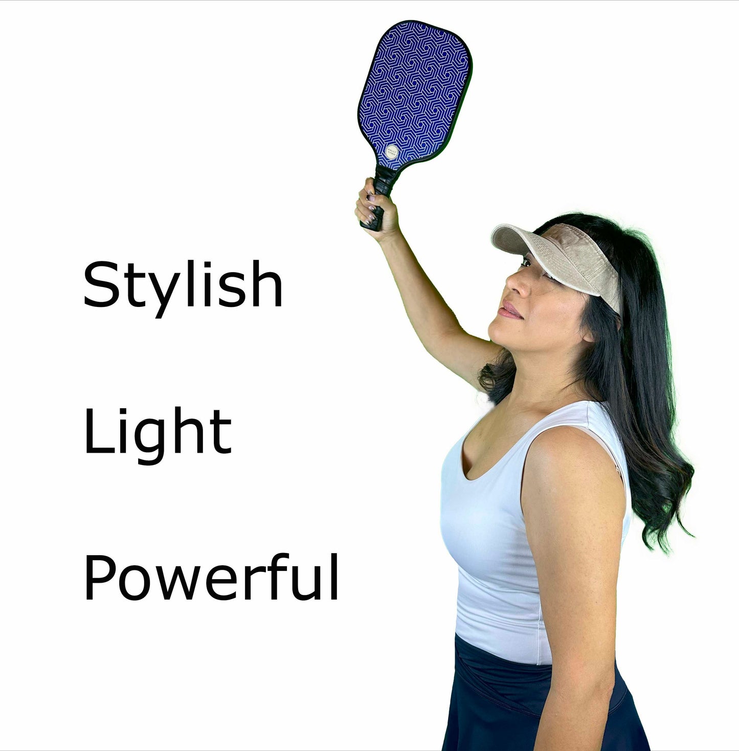 A woman in a white tank top, black skirt, and beige visor poses holding the Rally Titan Pickleball Blue Hex | 10MM paddle with T300 Textured Carbon Fiber Surface overhead. “Stylish,” “Light,” and “Powerful” appear beside her on a plain white background.