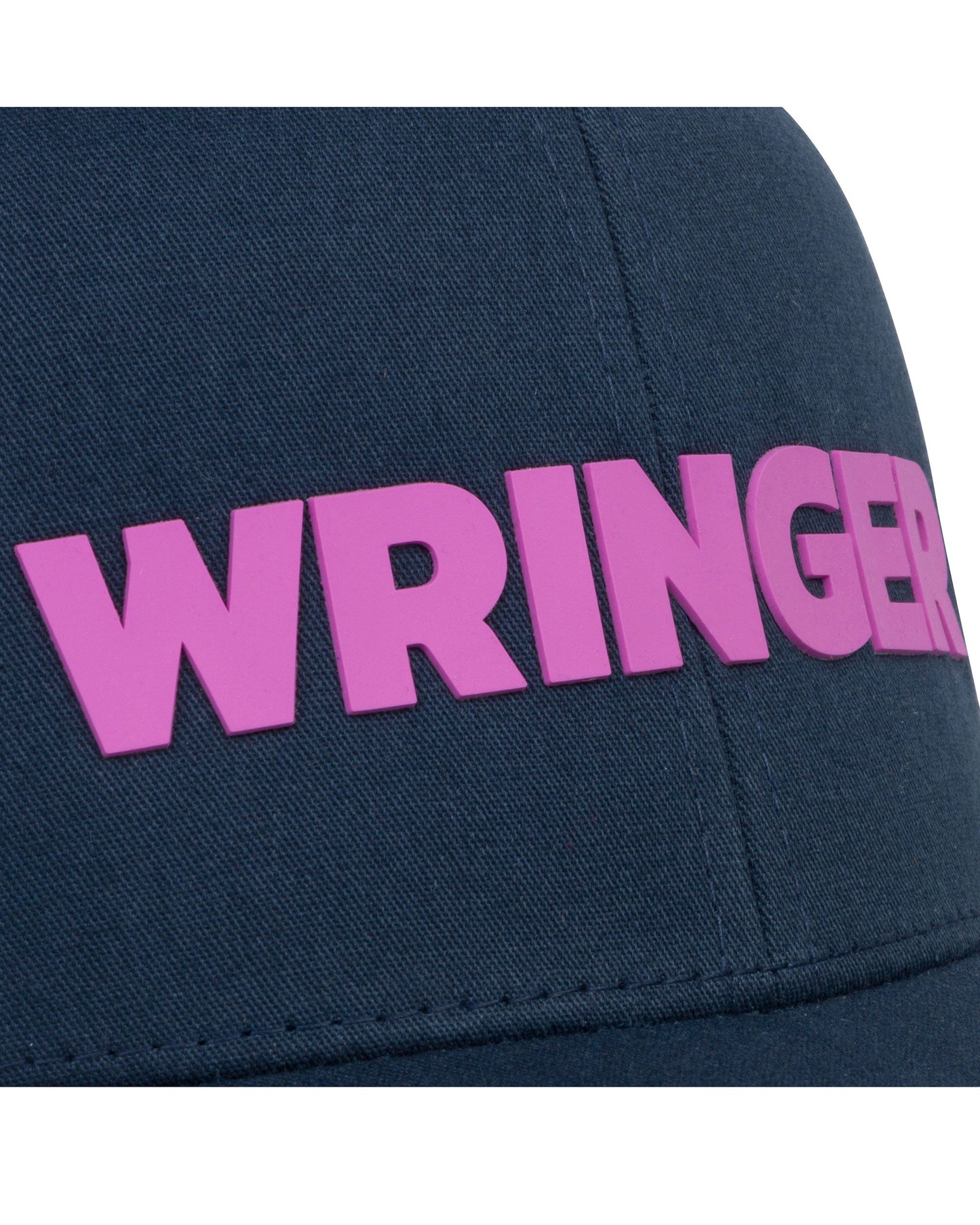 Close-up of the Wringer Wear Adjustable Mesh WRINGER Hat, a navy blue men's cap featuring bold bright pink "WRINGER" text across the front, a vertical seam through the fabric, and an adjustable mesh design for comfort.