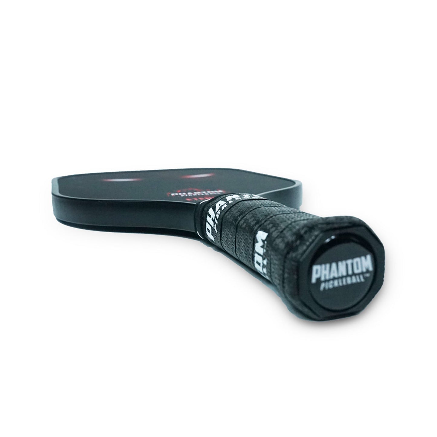 Close-up of the Phantom Eternal 14MM T700 Carbon Fiber Pickleball Paddle by Phantom Pickleball, showing the textured grip tapering toward the blurred paddle face—set against a white background; ideal for beginners. Includes cover.