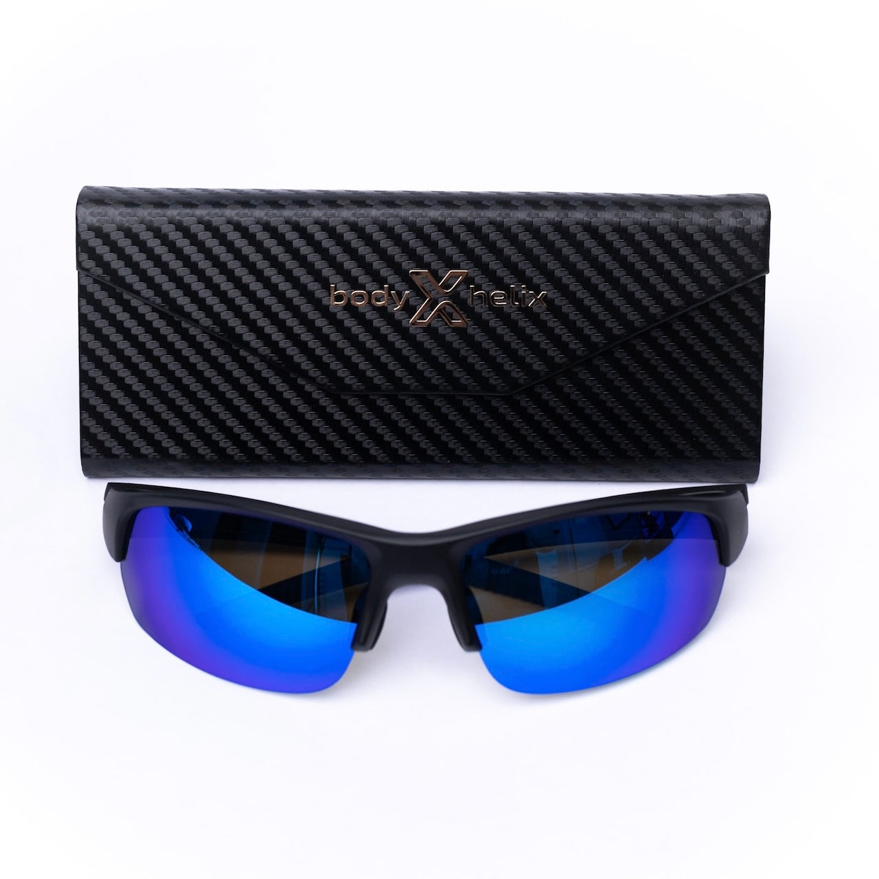 A pair of black body helix Pickleball Glasses with blue mirrored lenses sits below a black, carbon fiber-patterned case featuring the gold bodyXmetrix logo and text, all displayed on a white background.