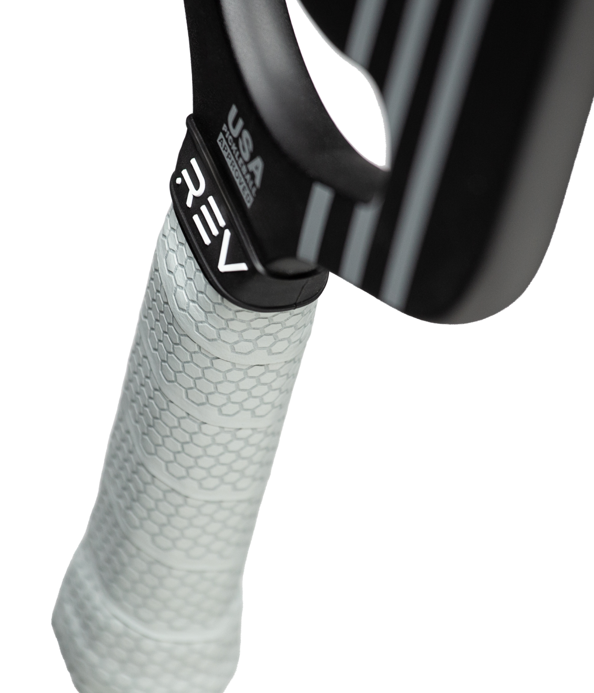 Close-up of the PLATINUM Pickleball Paddle handle by REV Pickleball, wrapped in a textured light gray grip. The black neck shows "REV" and "USA PICKLEBALL APPROVED." This edgeless carbon fiber paddle contrasts against a plain white background.