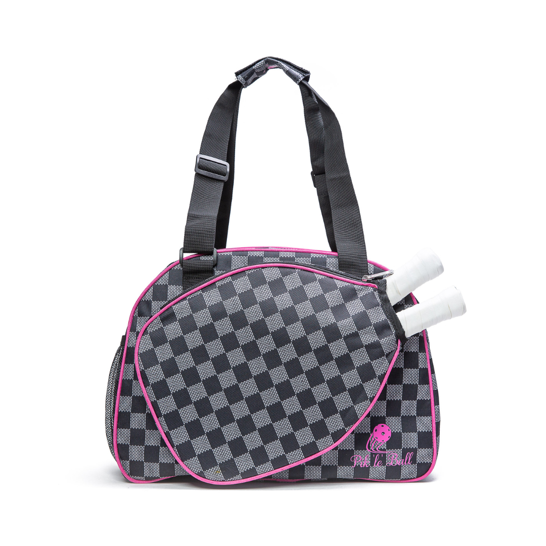 The Pik'le'Ball Sports Checkered Chic Premium Women's Pickleball Bag features padded compartments, an adjustable strap, and a stylish black-and-white design with pink trim.