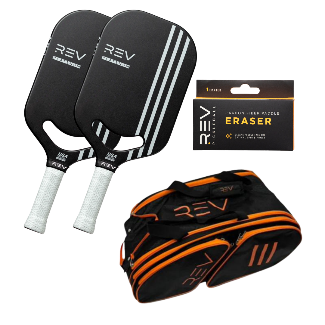 The REV Pickleball Professional - Mix & Match - Bundle for 2 includes two black paddles with white stripes and grips, a black and orange REV sports duffel bag, and a Carbon Fiber Paddle Eraser, shown on a white background.