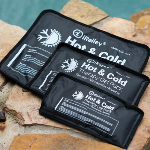 Three black iReliev Premium Reusable Hot and Cold Therapy Gel Packs with Securement Straps in various sizes are shown on tan stone tiles, featuring white text and icons for versatile hot or cold pain relief.