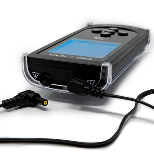A close-up of the iReliev SPORT Muscle Stimulator with Explosive Strength Mode shows its black digital interface, multiple buttons, and connected wires. The muscle stimulation device is in a clear case and rests on a white surface.
