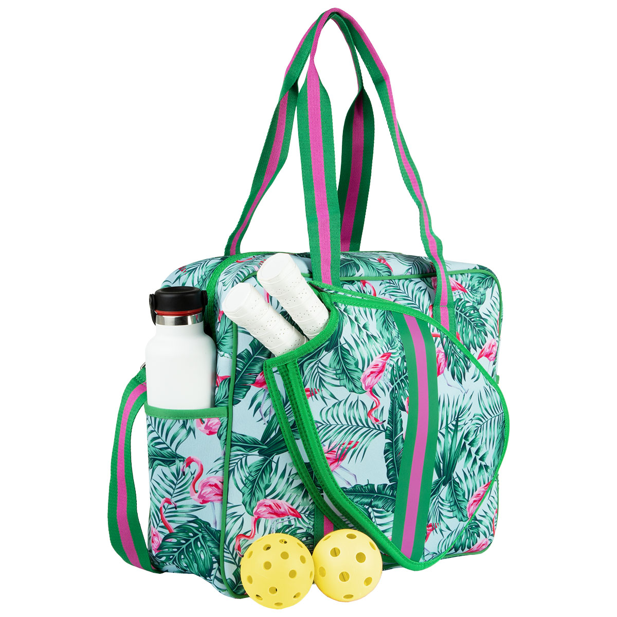 The Brooklyn Pickleball Bag by Queen of the Court is a colorful neoprene bag with a blue background, pink flamingo and green leaf print, striped handles, water bottle and tube pockets, plus two yellow pickleballs nearby.