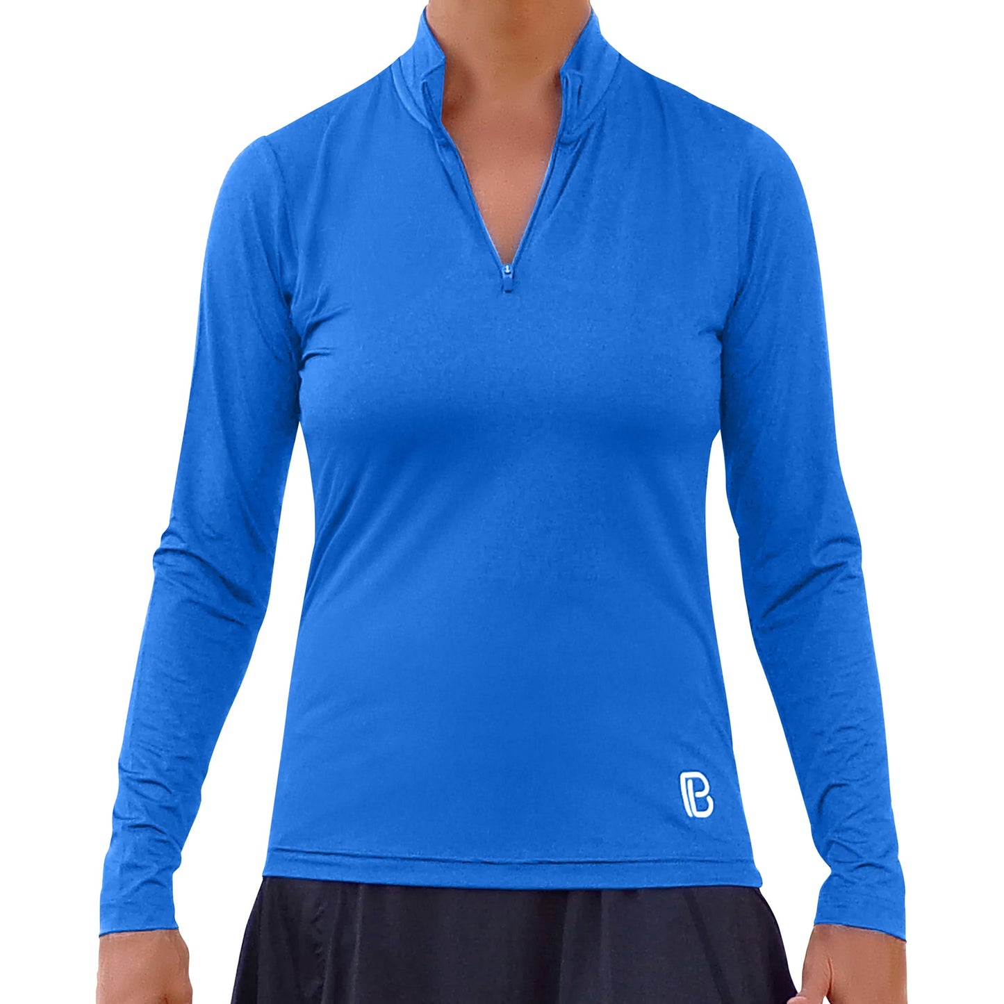 A person faces forward wearing the Pickleball Bella PB 1/4 Zip Long Sleeve Royal Blue with SPF 50+ UV protection and a small white logo by the lower left hem, paired with a black skirt. The background is plain white.