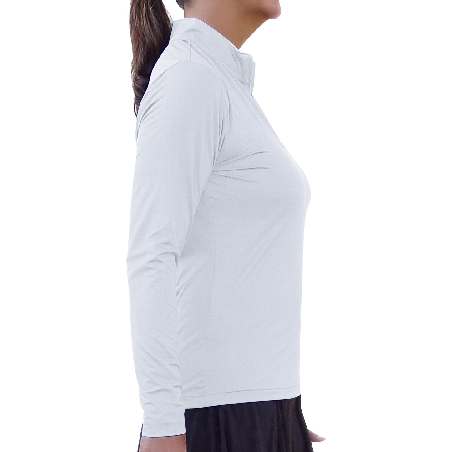 A woman with her hair in a ponytail faces right, wearing Pickleball Bella's PB 1/4 Zip Long Sleeve Classic White shirt with SPF 50+ UV protection and a high collar, paired with a black skirt, against a seamless white background.