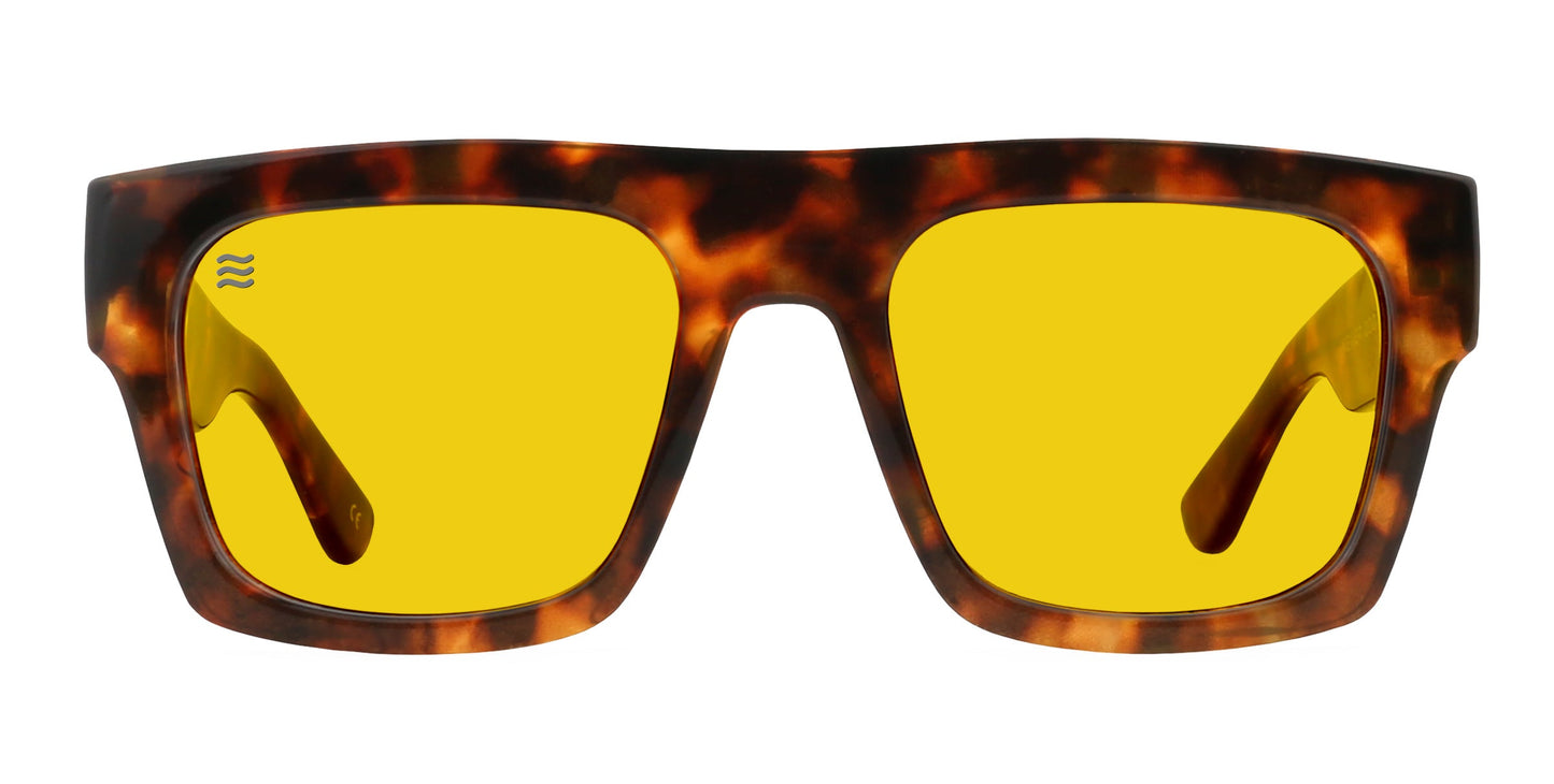 The Amar sunglasses by Neven Eyewear feature rectangular tortoise shell frames, glossy finish, bright yellow lenses, and a blue wave symbol on the upper left lens—a bold fashion statement. Shown front view on a white background.