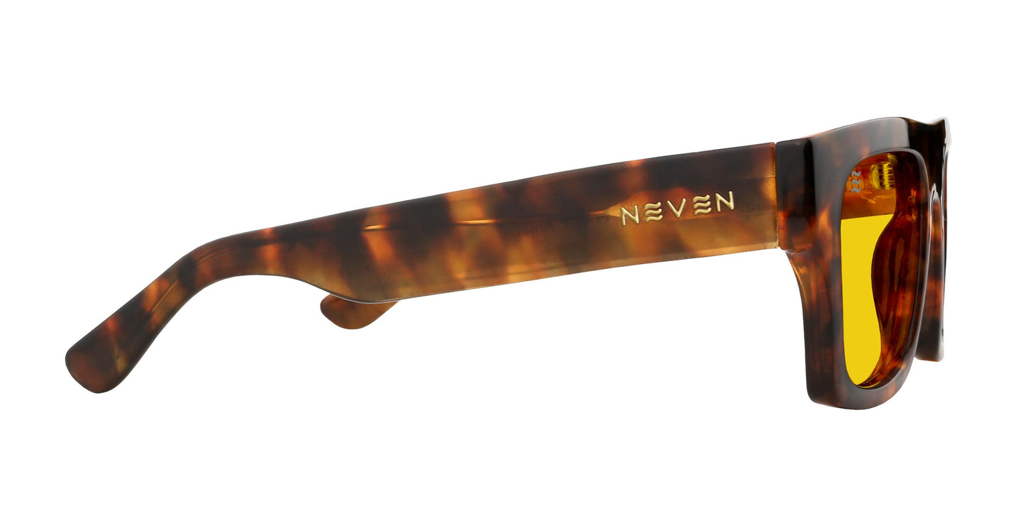 Side view of Neven Eyewear's Amar sunglasses in a chunky, rectangular tortoise shell design with yellow-tinted lenses and the gold “NEVEN” logo printed on the arm near the hinge.