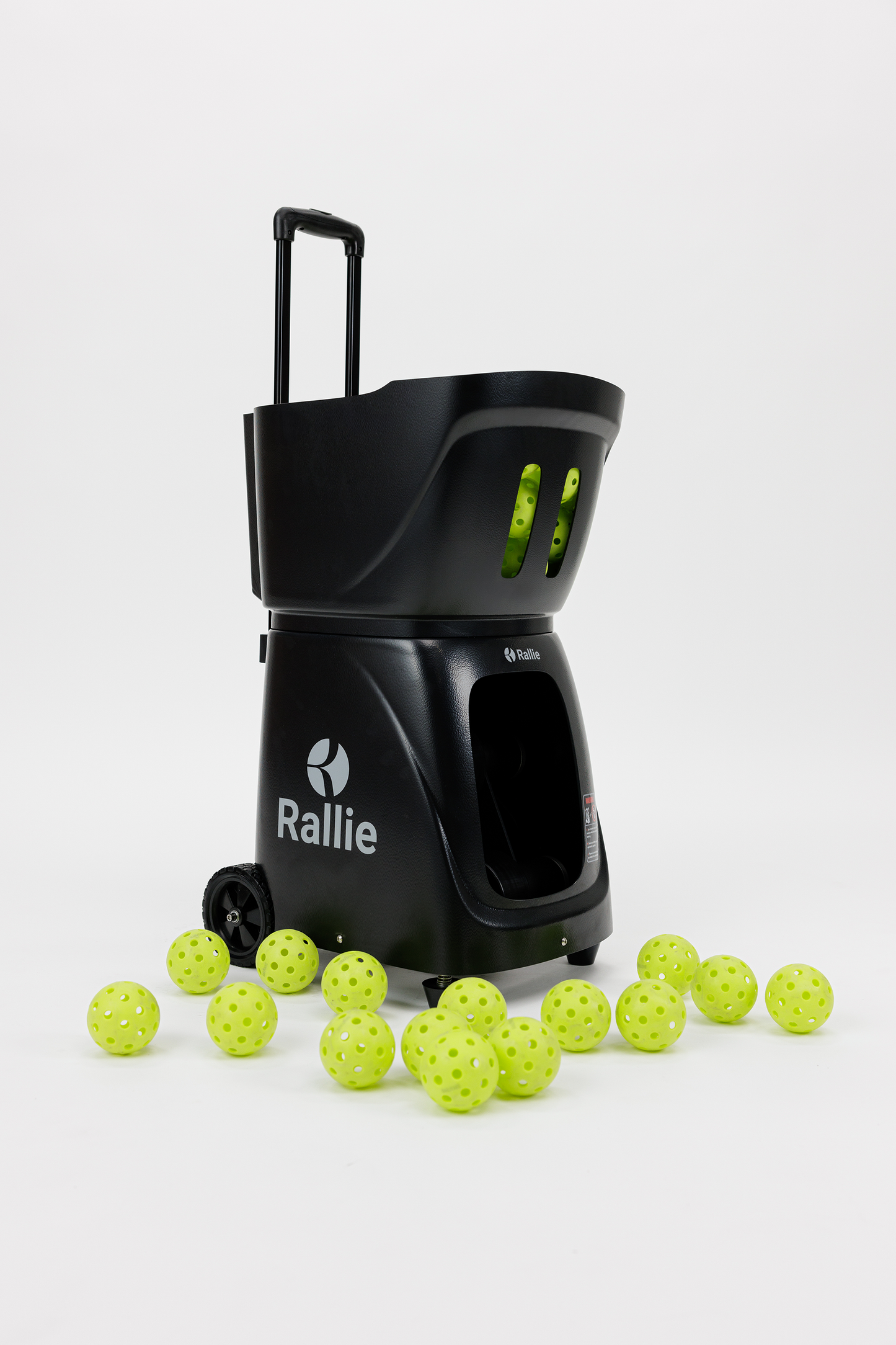 The Rallie Pickleball Machine - Midnight Black by Rallie Pickleball is a portable, wheeled machine shown on a white background, dispensing bright yellow pickleballs with four balls visible in its front compartment—ideal for efficient training.