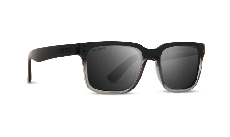 The Romeo by Epoch Eyewear are modern, stylish polarized sunglasses with a thick black full-frame and dark lenses. Arms are black; the frame subtly fades to translucent gray at the bottom—perfect for travel and adventure.