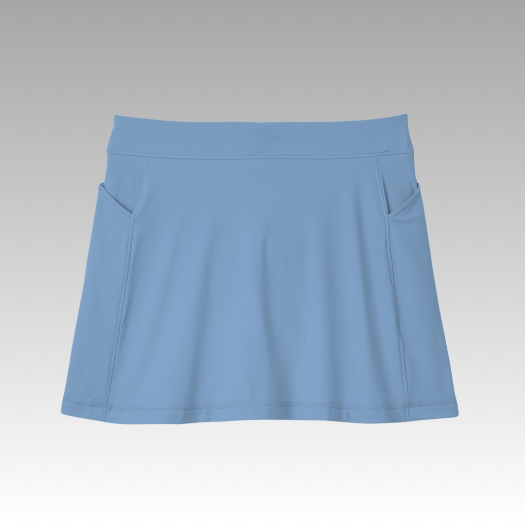 The Sammy Skort 2.0 from Playly Store is a light blue high-waisted pickleball skort featuring a wide waistband, subtle side pockets, smooth stitching, and CoolFlow fabric, set on a gray-to-white gradient background.