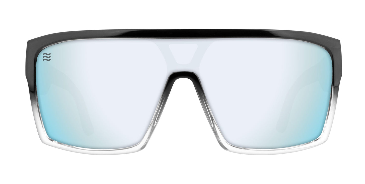 Neven Eyewear’s Inlet sunglasses feature a wide, single-piece blue mirrored lens with polarized UV400 protection, a thick black/clear frame, and a wave logo inspired by Sebastian Inlet on the top left corner.