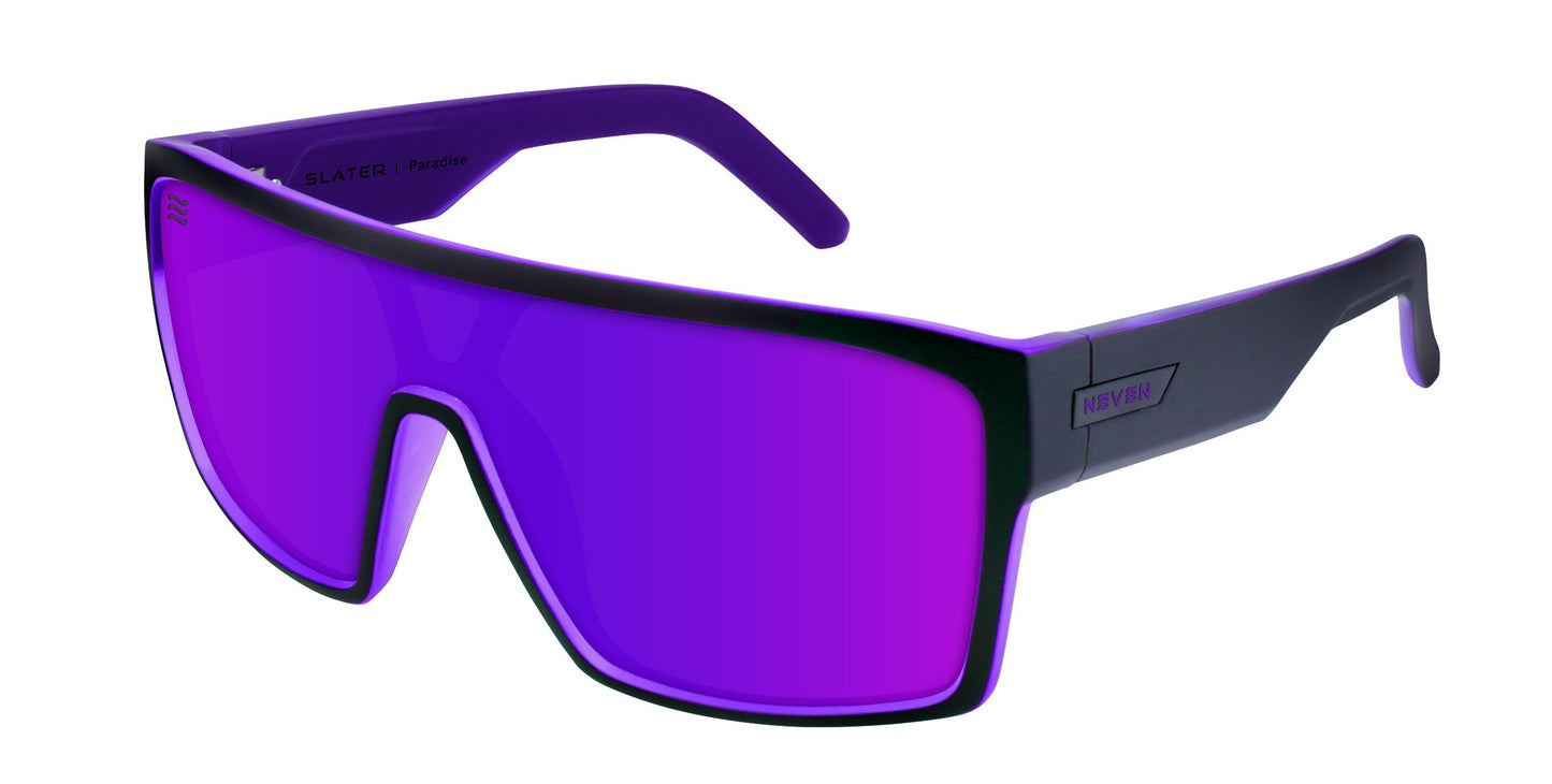 Neven Eyewear’s Paradise sunglasses feature a thick black wraparound frame and a large purple-tinted lens—perfect for surfing at Paradise Beach. The arms are black with purple interiors and “HYPERVIEW” branding by the left hinge.