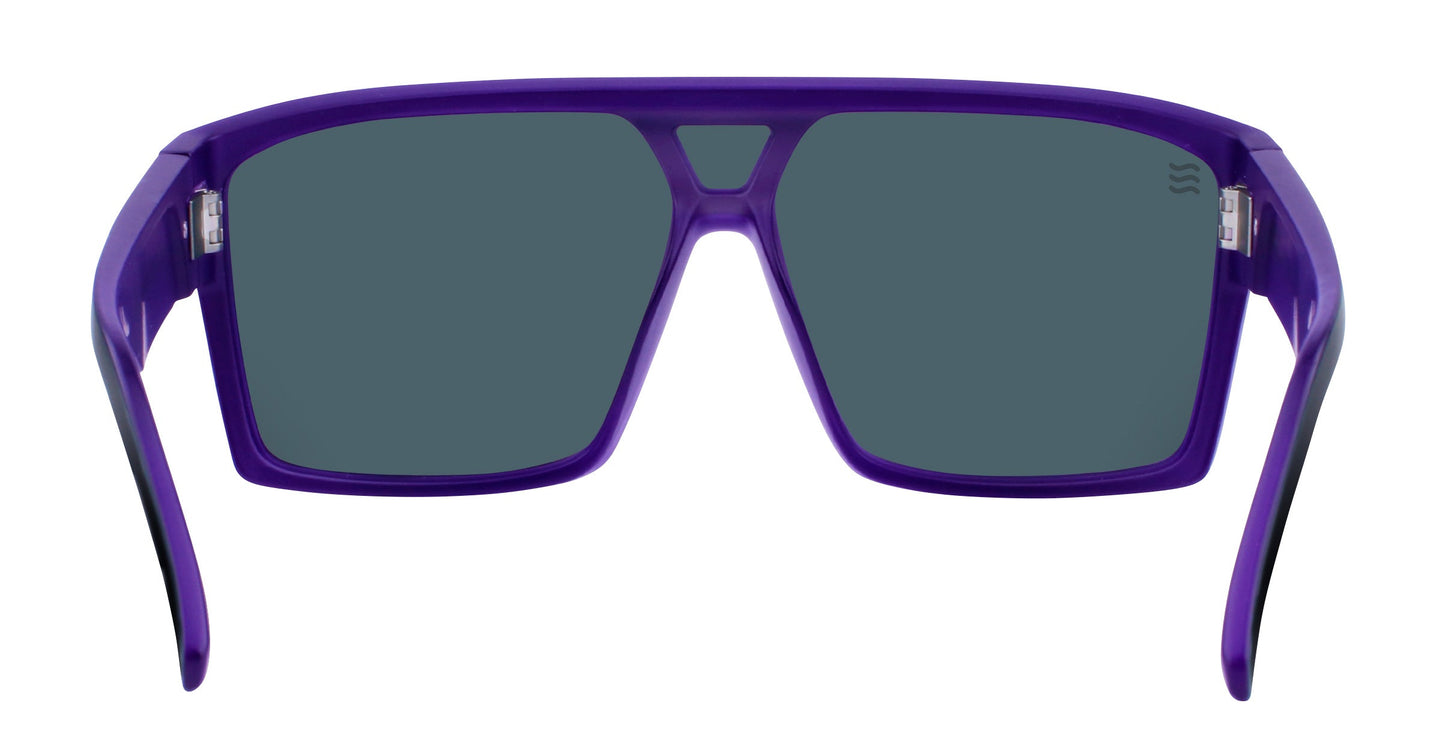 Paradise by Neven Eyewear are wide, oversized polarized sunglasses with a bold purple plastic frame and large, dark rectangular lenses. The flat top bar and thick, outward-curving arms offer a sleek, modern look for Paradise Beach outings.