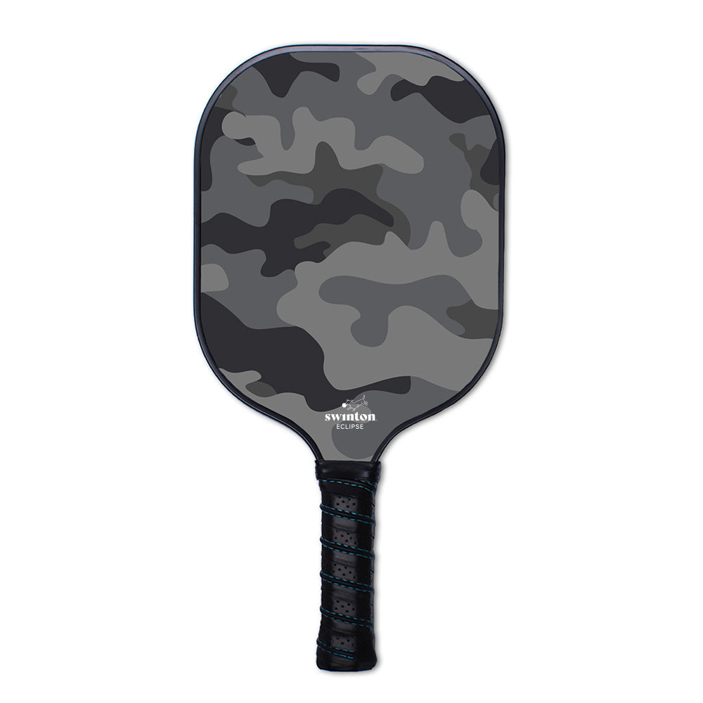 The Swinton Pickleball Eclipse Camo Paddle features a black and gray camo design, textured graphite face, black grip handle, and USA Pickleball approval. The brand name appears near the base on a plain white background.