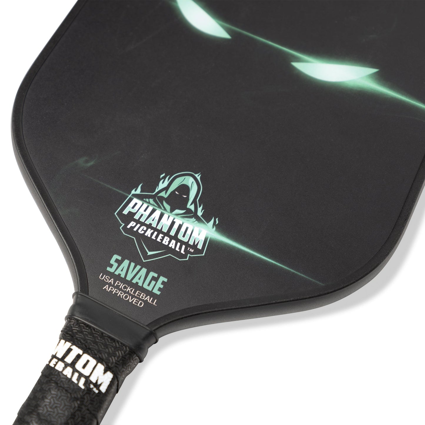 A close-up of the PHANTOM SAVAGE 13MM T800 Carbon Fiber Pickleball Pro Paddle by Phantom Pickleball, showing glowing green eyes, a hooded logo above “SAVAGE,” “USA Pickleball Approved,” and a textured handle with the brand name.