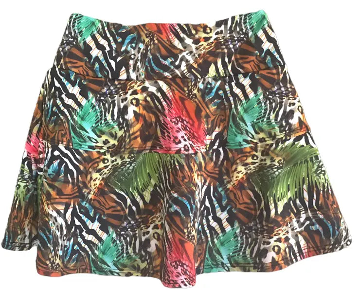 The Nola Go Wild Court Skirt by Runway Athletics is a flared A-line tennis skirt with vibrant animal prints—zebra, leopard, and green palm leaves—featuring a wide waistband, shaping panels, and a moisture-wicking under-short for comfort.