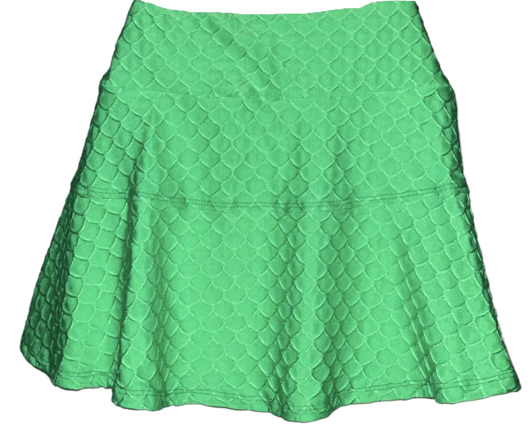 The Nola Lime Scallop Skirt by Runway Athletics features a green A-line silhouette, textured scallop-patterned fabric, a horizontal waist seam, and a ruffled hem for a blend of classic style and sporty tennis skirt vibes.