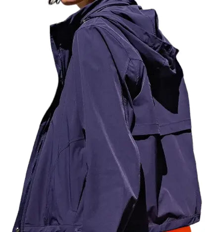 A person is seen from the back and side wearing a Lightweight Navy Zip Up Hoodie by Runway Athletics. The hoodie has visible seams, long sleeves, and a relaxed fit. Only the lower face and neck are shown against a white background.